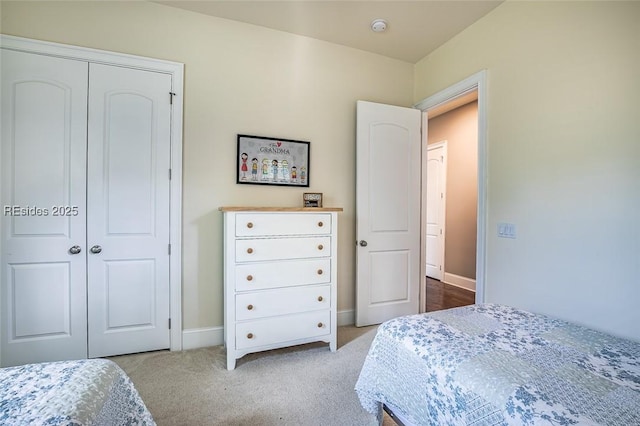 bedroom with light colored carpet and a closet