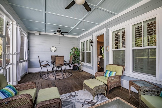 sunroom / solarium featuring ceiling fan