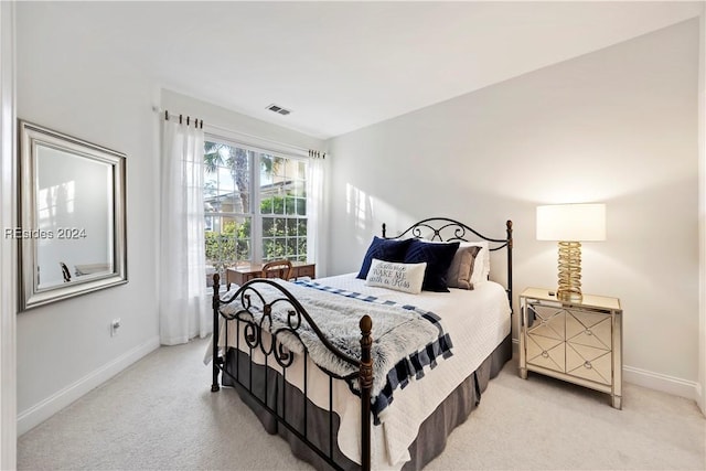 bedroom featuring light carpet