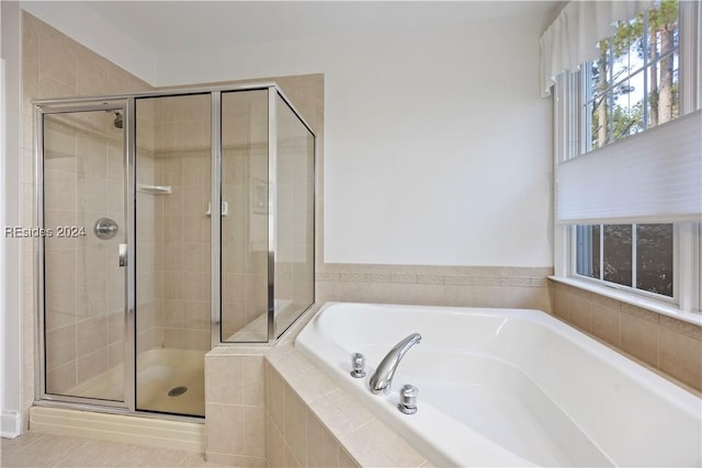 bathroom with tile patterned floors and shower with separate bathtub