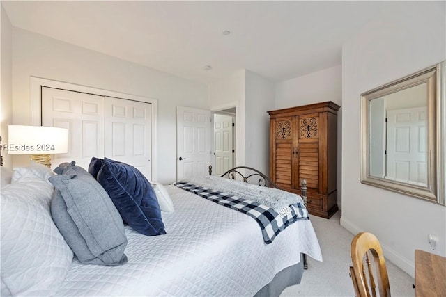 bedroom featuring light colored carpet and a closet