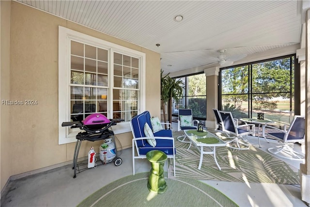 sunroom / solarium featuring ceiling fan