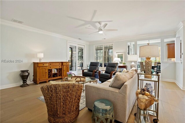 living room with ornamental molding, ceiling fan, and light hardwood / wood-style flooring