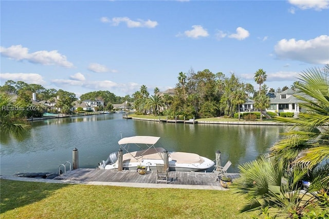 view of dock with a water view and a yard