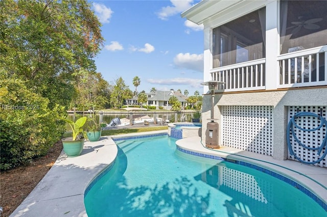 view of swimming pool with a sunroom and an in ground hot tub