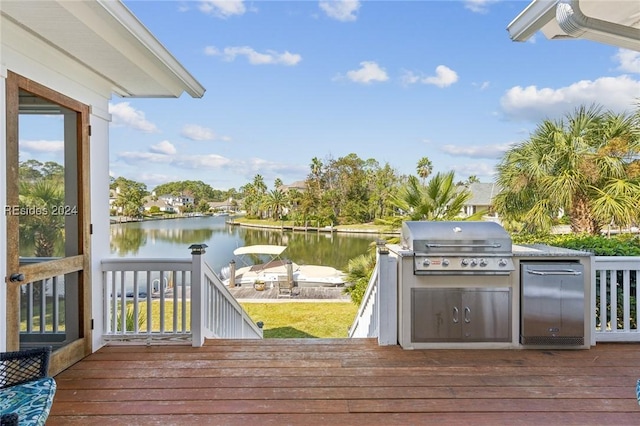 deck featuring area for grilling and a water view