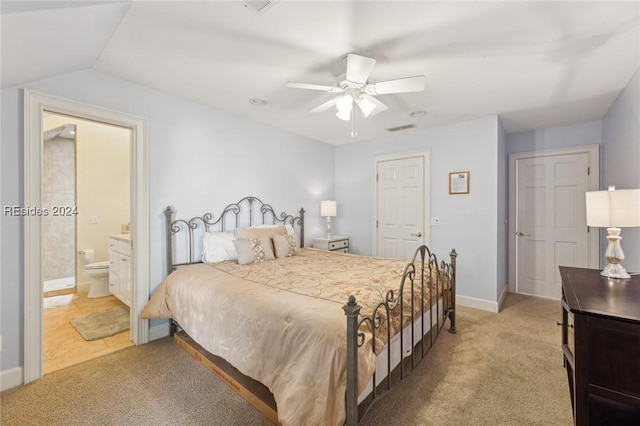 carpeted bedroom featuring vaulted ceiling, ceiling fan, and ensuite bathroom