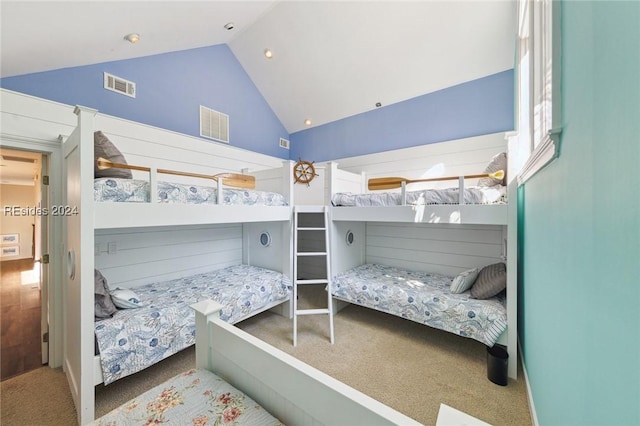 carpeted bedroom with lofted ceiling