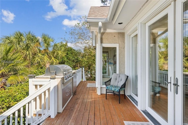 wooden deck featuring a grill, area for grilling, and french doors