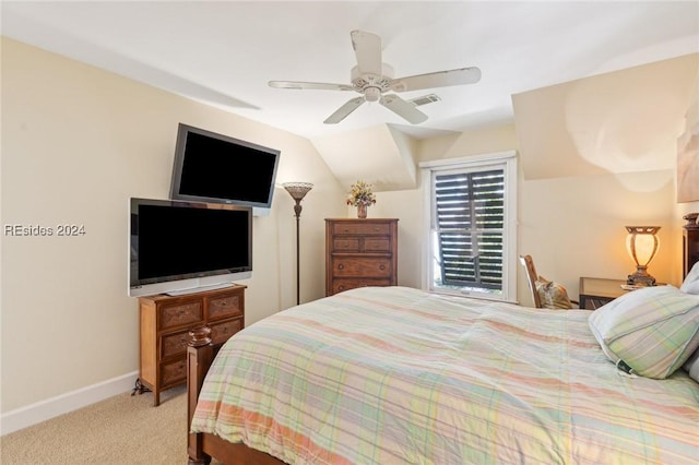 carpeted bedroom featuring ceiling fan and vaulted ceiling