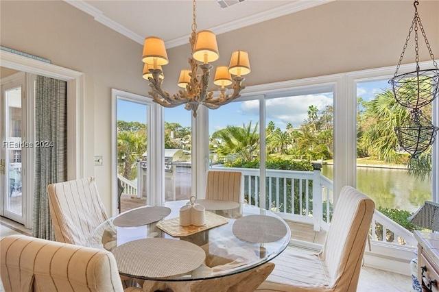 sunroom / solarium with a water view, a notable chandelier, and a wealth of natural light