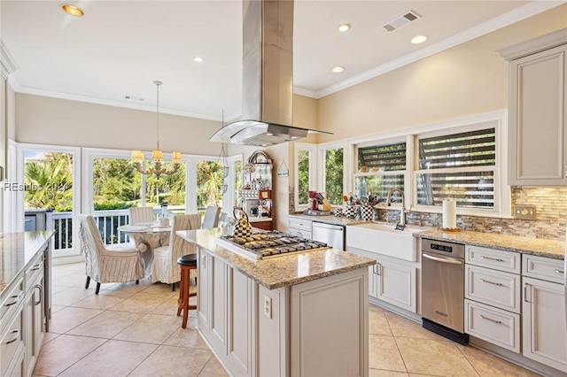 kitchen featuring light stone counters, island range hood, appliances with stainless steel finishes, and a kitchen island