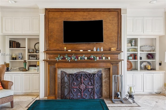 living room featuring built in shelves and ornamental molding