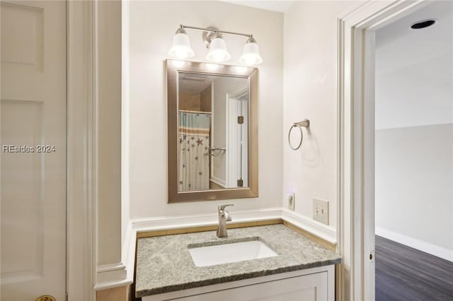 bathroom with vanity, hardwood / wood-style floors, and a shower with shower curtain