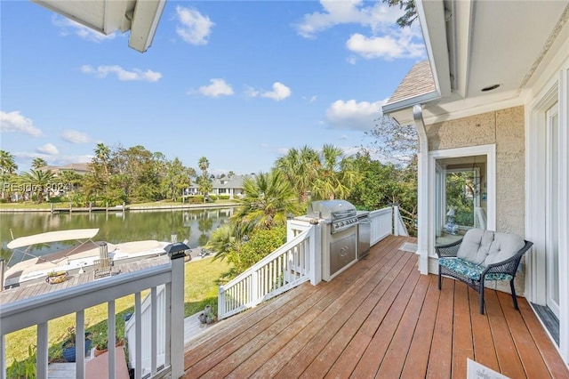 wooden deck featuring a water view and area for grilling