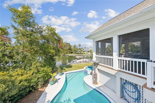 view of swimming pool with a water view and a sunroom