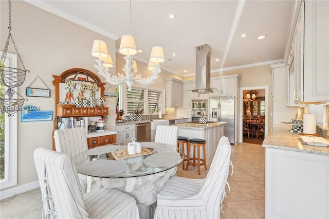 tiled dining room featuring crown molding and a chandelier