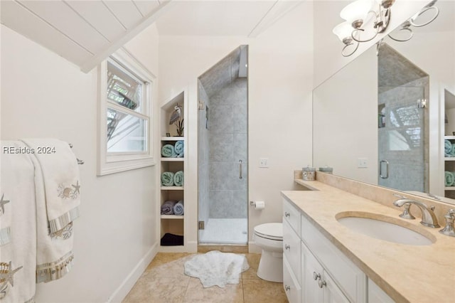 bathroom with tile patterned flooring, vanity, a notable chandelier, toilet, and walk in shower