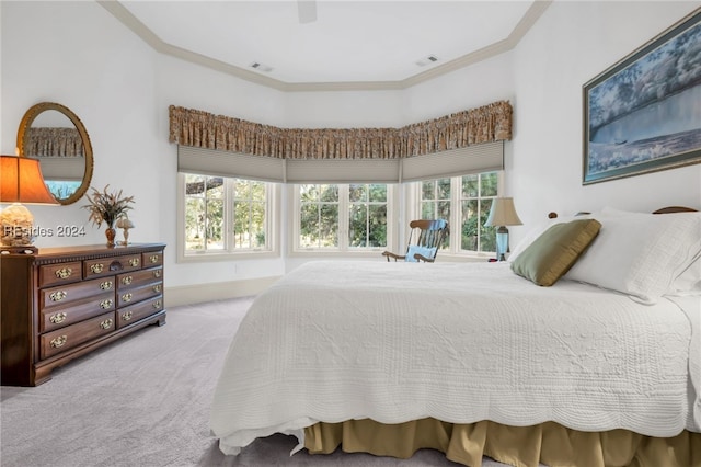 carpeted bedroom with ornamental molding and ceiling fan