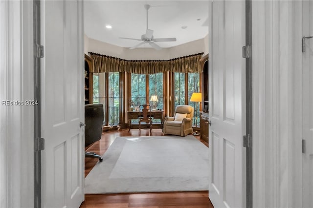 sitting room with hardwood / wood-style flooring and ceiling fan