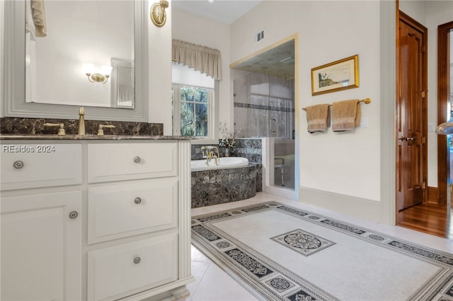 bathroom featuring vanity, tile patterned flooring, and shower with separate bathtub