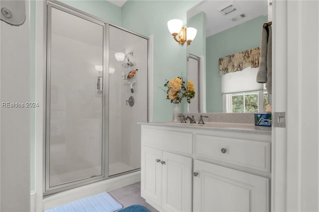 bathroom featuring vanity and an enclosed shower