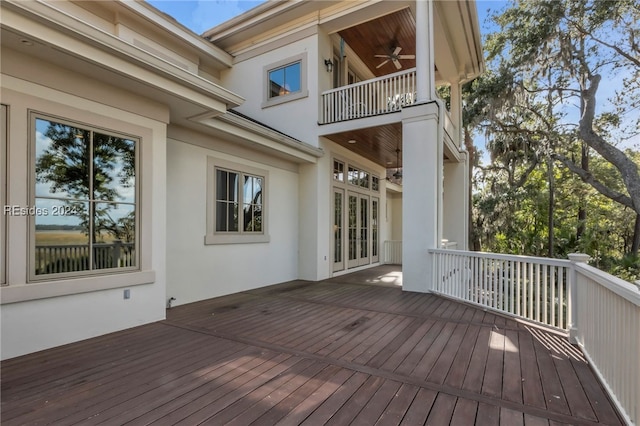 wooden deck featuring ceiling fan