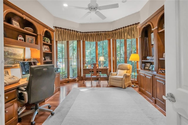 home office featuring light hardwood / wood-style flooring, plenty of natural light, and ceiling fan