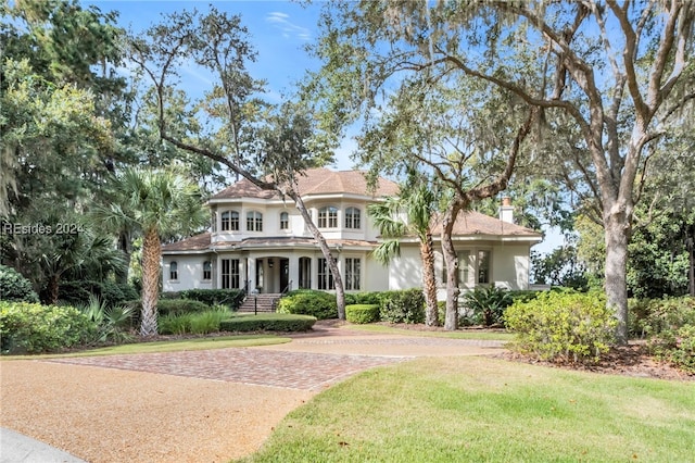 mediterranean / spanish home featuring a front yard