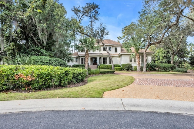 mediterranean / spanish house with a front lawn