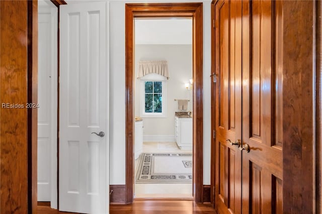 corridor with light hardwood / wood-style floors