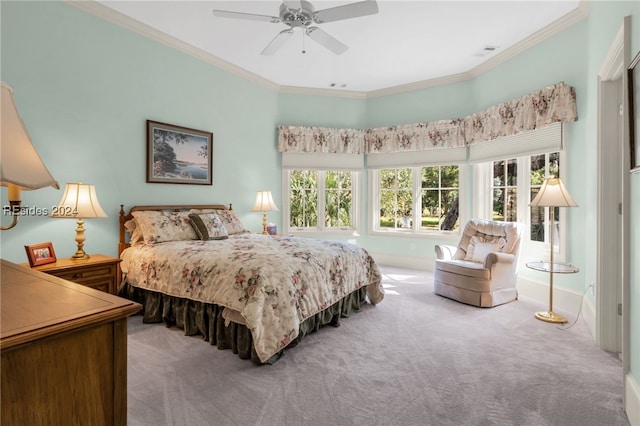 carpeted bedroom with crown molding and ceiling fan