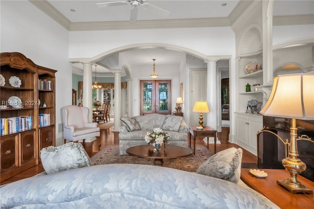 living room featuring ornate columns, crown molding, hardwood / wood-style floors, and ceiling fan