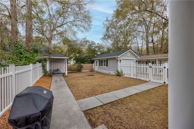 view of yard with a garage and an outdoor structure