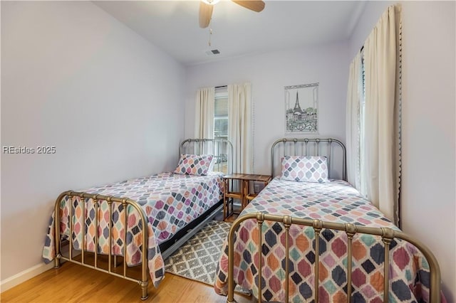 bedroom featuring hardwood / wood-style flooring and ceiling fan