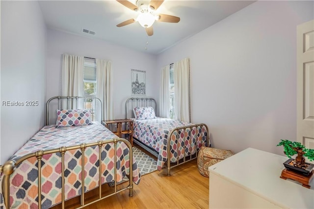 bedroom featuring hardwood / wood-style flooring and ceiling fan