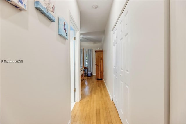 corridor with light hardwood / wood-style floors