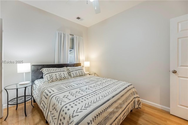 bedroom featuring light hardwood / wood-style floors and ceiling fan