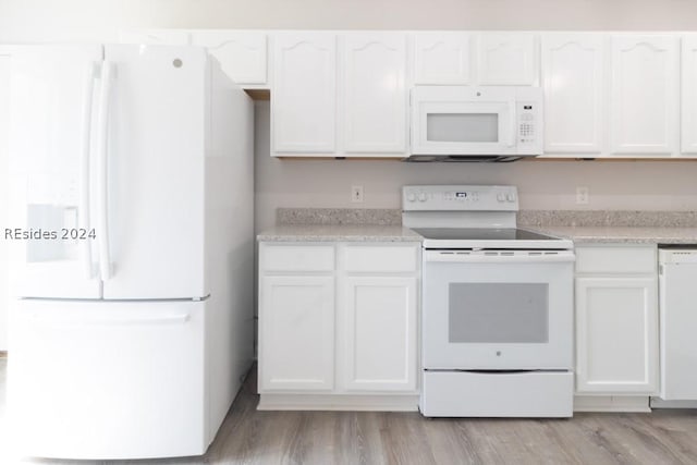 kitchen with white appliances, light hardwood / wood-style flooring, and white cabinets