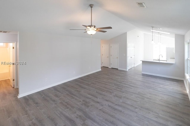 unfurnished living room with vaulted ceiling, sink, ceiling fan, and dark hardwood / wood-style flooring