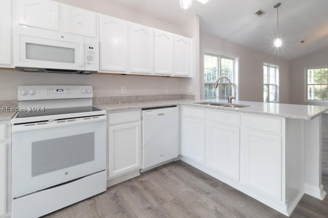 kitchen featuring vaulted ceiling, sink, white cabinets, and white appliances