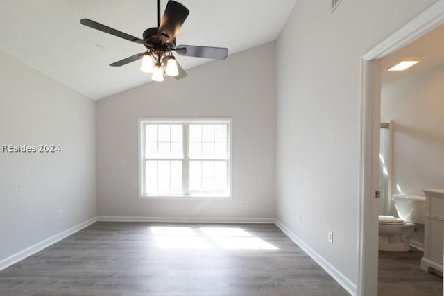 spare room with lofted ceiling, dark hardwood / wood-style floors, and ceiling fan