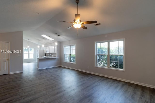 unfurnished living room featuring ceiling fan, dark hardwood / wood-style floors, and vaulted ceiling