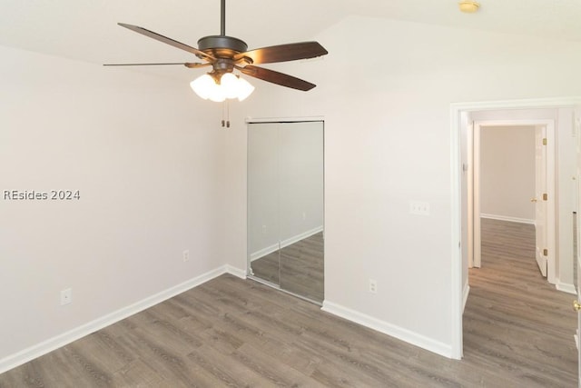 interior space featuring vaulted ceiling, dark hardwood / wood-style floors, and ceiling fan