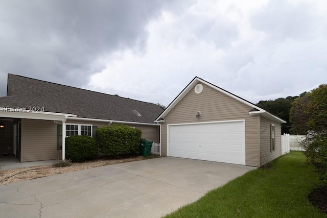 ranch-style house with a garage and a front yard