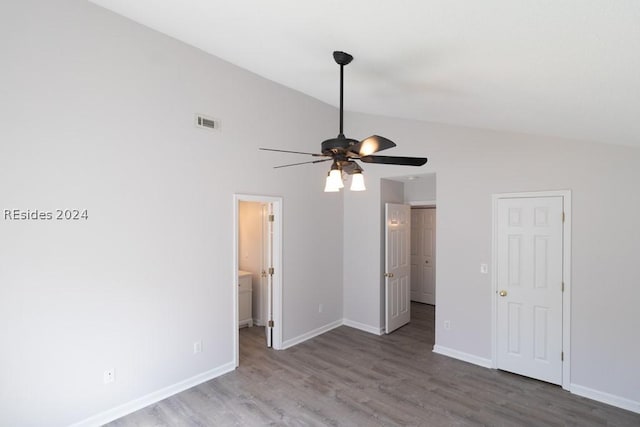 unfurnished bedroom with hardwood / wood-style flooring, vaulted ceiling, ceiling fan, and ensuite bathroom