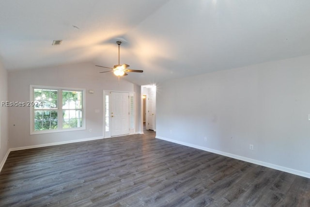 empty room featuring vaulted ceiling, dark hardwood / wood-style floors, and ceiling fan