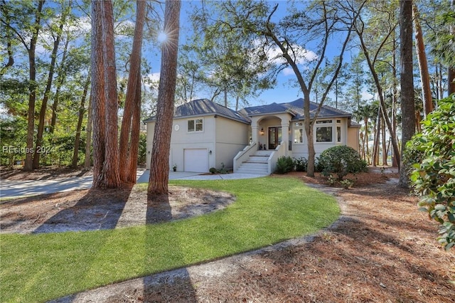 view of front of property featuring a garage and a front lawn