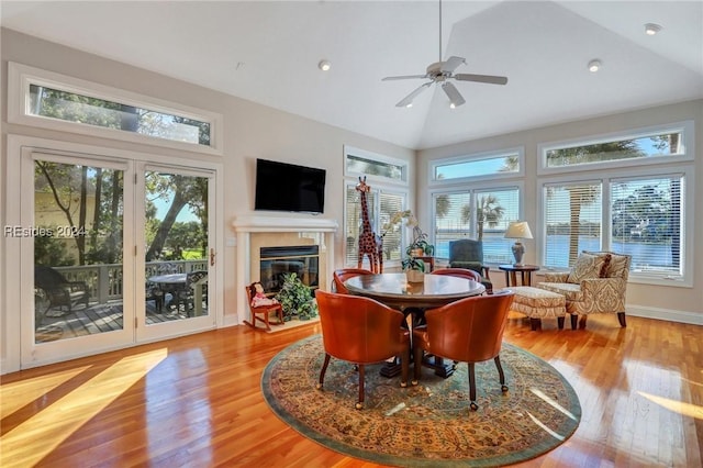 dining room featuring ceiling fan, lofted ceiling, and light wood-type flooring