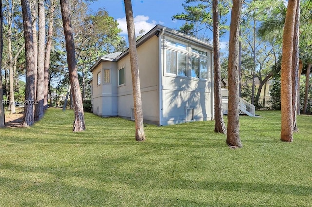 view of side of home featuring a yard